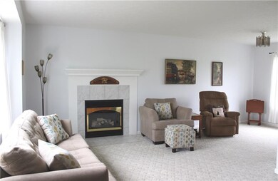 Living room/dining room highlighted by gas firepla