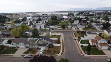 Aerial overview of property's location featuring nearby suburban area and a mountainous background