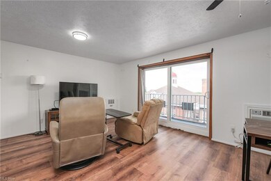 Hardwood floored living room featuring a textured 