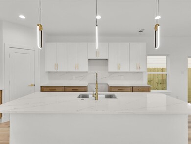Kitchen with a kitchen island with sink, sink, and