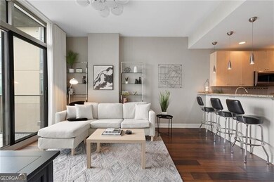 Living area with dark wood finished floors and recessed lighting