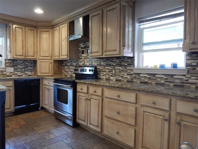 Kitchen with wall chimney range hood, stainless st