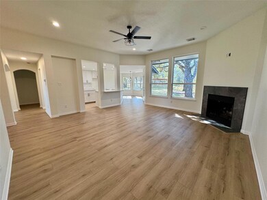 Unfurnished living room featuring a tile fireplac