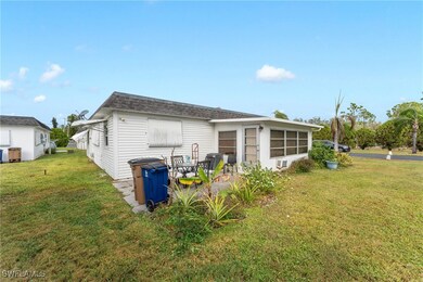 Back of house featuring a lawn and a patio