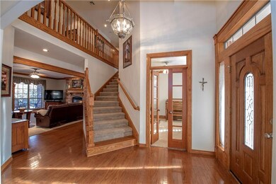 Impressive vaulted entry with wood floors