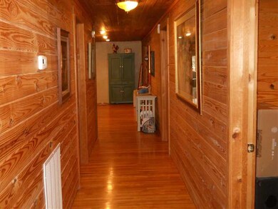 Interior Space/Layout. Gleaming hardwood floors and wood walls.
