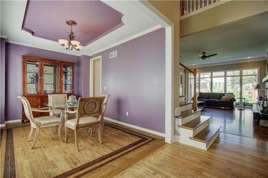 Dining room w/ vaulted ceilings and hardwoods.