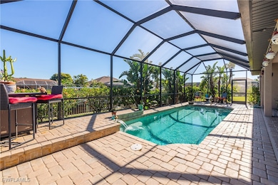View of swimming pool with a patio area and a lanai