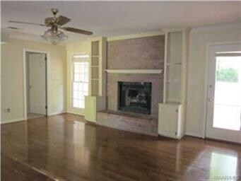 with fireplace and another door leading to the cov