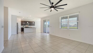 Spacious great room, kitchen & sliders leading to lanai.