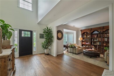 Foyer entrance with hardwood floors, healthy amount of natural light,  and ornamental molding