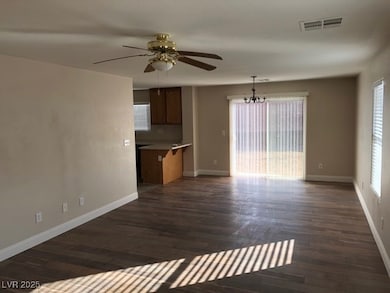 Unfurnished living room featuring ceiling fan, dar
