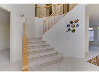 A grand staircase opens up the two-story entryway 