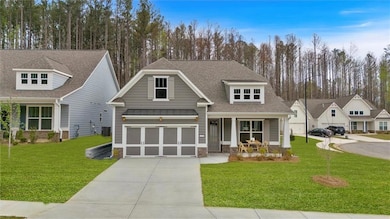 Craftsman house with a porch, concrete driveway, a standing seam roof, and a front lawn