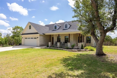 View of front of home with stone siding, a porch,