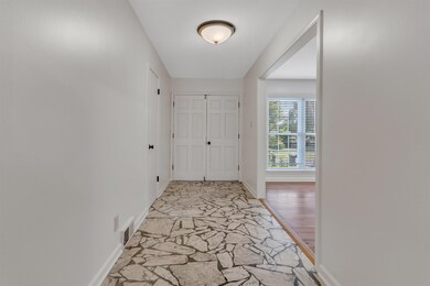 Hall with stone flooring and baseboards