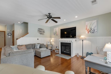 Living room with ceiling fan, recessed lighting, a