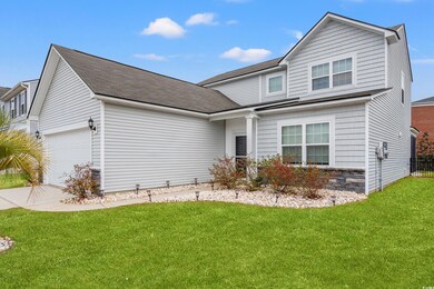 Traditional-style home with a garage, driveway, an