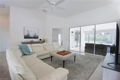 Living room with ceiling fan, lofted ceiling, and 