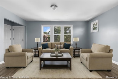 Living room with wood finished floors and healthy amount of natural light