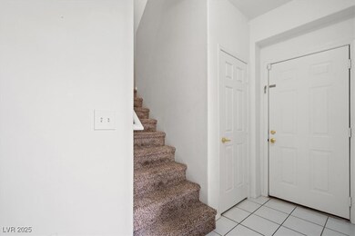 Foyer entrance with stairway and light tile patter