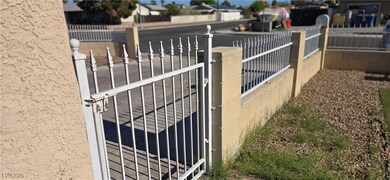 Exterior view of a fenced front yard, a gate, and