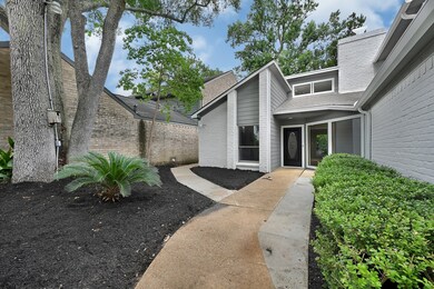 Fresh mulch and lush greenery frame the entry.