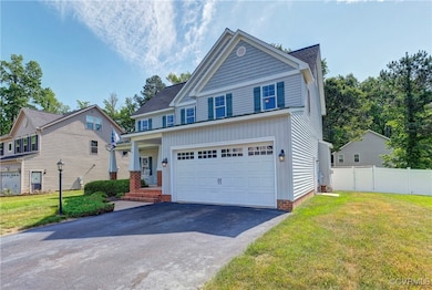 Craftsman-style home featuring asphalt driveway an