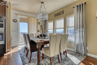 Dining area featuring a notable chandelier, hardwo