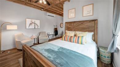 Bedroom featuring an AC wall unit, wooden ceiling