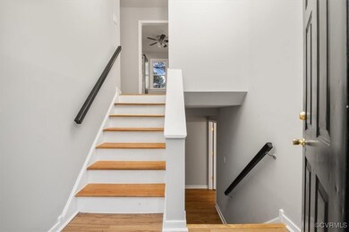 Stairway featuring hardwood / wood-style flooring
