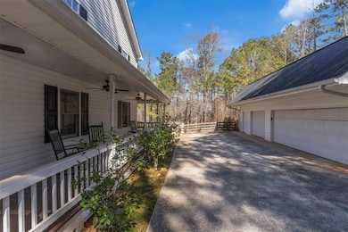 View of side of property featuring ceiling fan, a porch, roof with shingles, and fence
