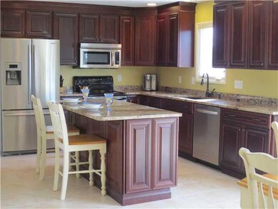 Kitchen Cherry cabinets, stainless steel appliance