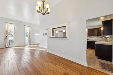 Living Room is open to Dining Room with pass-through window to Kitchen