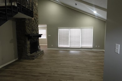 Unfurnished living room featuring high vaulted cei