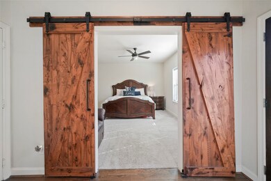 Custom barn doors frame the entrance to the first