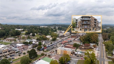 Aerial view of property and surrounding area with property parcel outlined