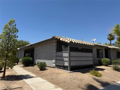 View of property exterior with stucco siding, a tile roof, and a garage