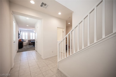Hall featuring recessed lighting, stairs, light ti