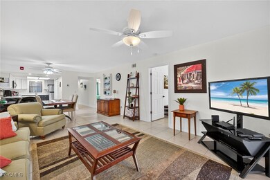 Living area with light tile patterned floors and ceiling fan