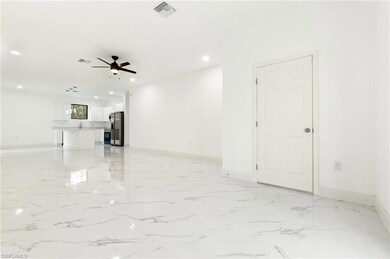 Unfurnished living room with a ceiling fan, recessed lighting, and light marble finish floors