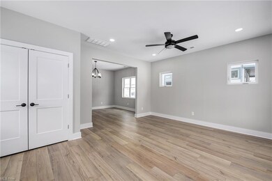 View of the living room from the front door. Large storage closet with access to under-stair storage.