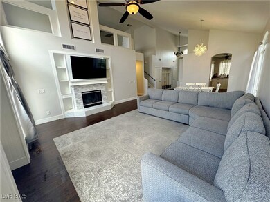 Living area with built in features, a ceiling fan,