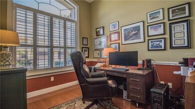Office features volume ceilings, plantation shutte