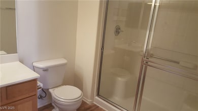 Bathroom with toilet, a shower stall, and vanity