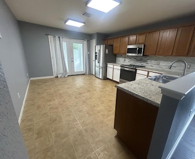 Kitchen featuring stainless steel appliances, a s
