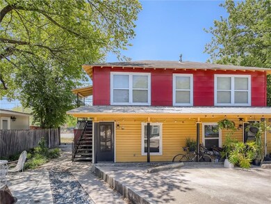 View of front of house with a patio area, stairs,