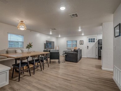 Dining area with a healthy amount of sunlight, a textured ceiling, and light hardwood / wood-style flooring