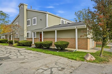 View of property exterior with brick siding, a shingled roof, and a chimney