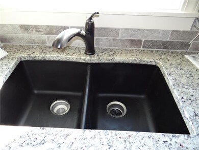 Granite undermount sink with oil-rubbed bronze pul